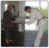 O'Sensei presents Darryl with Grand Master certificate.